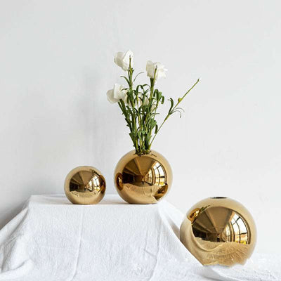Small, medium, and large electroplated ceramic gold vases for home decor.