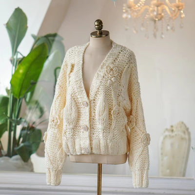 Handmade crochet batwing sleeve V-neck sweater in milky white wool on mannequin.