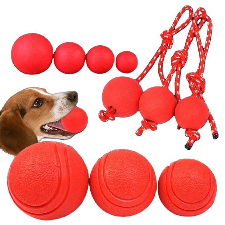 Red dog ball for training and chewing, made of solid rubber with elastic rope, ideal pet toy.