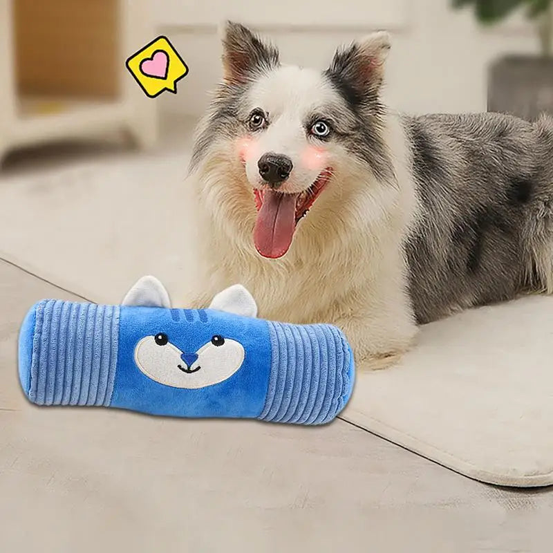 Puppy chewing on plush squeaky toy cylinder, interactive dog toy for play and enrichment.