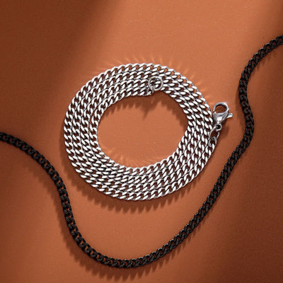Slim stainless steel women's necklace with Cuban link chain in silver and black.