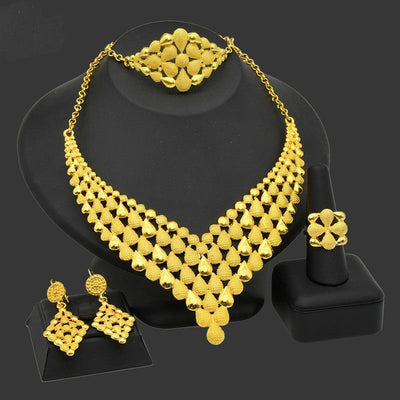 Nigeria Dubai 24k Gold Jewelry Suit with Necklace, Bracelet, Ring, and Earrings on Display.